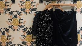 clothes hanging on a wall rack, pineapple wallpaper