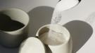 Spoon pouring sugar into a sugarbowl
